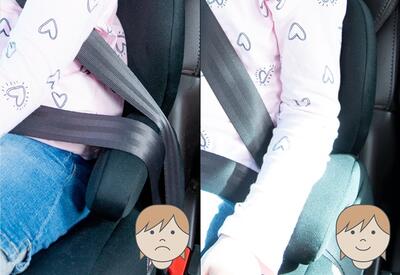 Kind in autostoel met gordel boven armleuning